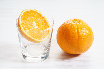 Fresh sliced orange with glass