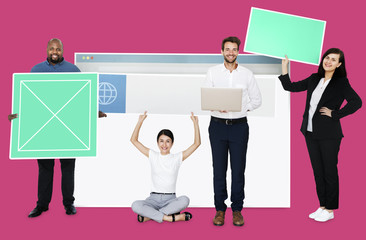 Happy diverse people holding a web design