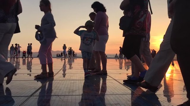 Time Lapse of people walking in sunset time in town of Zadar in Croatia. Place called greetings to the Sun.