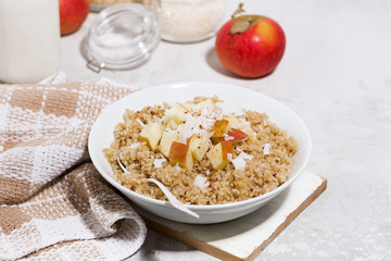 healthy breakfast quinoa with apple and coconut on white table
