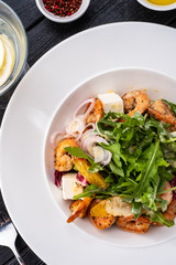 Fresh Sicilian Salad with shrimps, arugula, cheese and ripe orange slices.