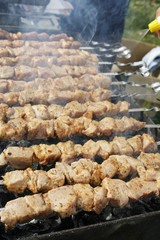 Grilled kebab cooking on metal skewers (grill).