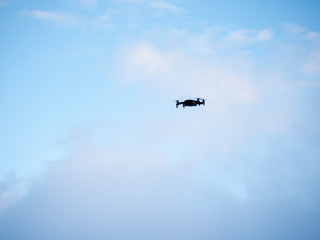 Fototapeta na wymiar Drone hovering against Blue sky.