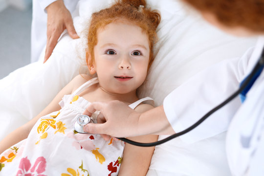 Doctor examining a little girl with stethoscope.Medicine and healthcare concept