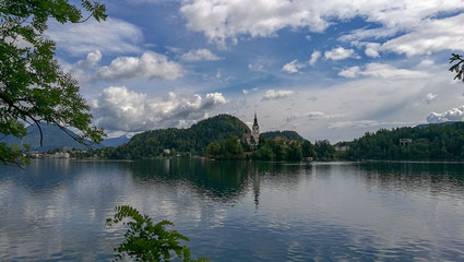Aerial view of Bled lake in Slovenia with beautiful clouds in the background