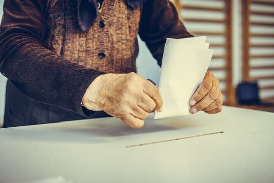 Person voting, casting a ballot