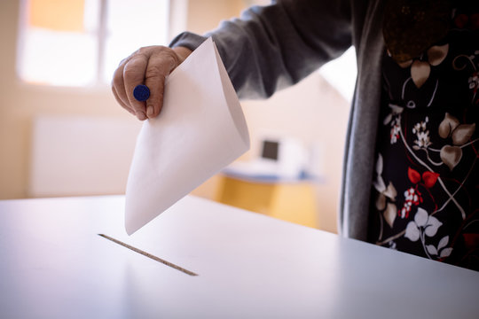 Person voting, casting a ballot