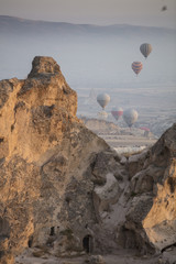 Unreal world of Cappadocia. Colorful sunrise in Red Rose valley in April. Cavusin village located, Nevsehir Province in the Cappadocia region of Turkey, Asia. Traveling concept background