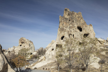 Unreal world of Cappadocia. Colorful sunrise in Red Rose valley in April. Cavusin village located, Nevsehir Province in the Cappadocia region of Turkey, Asia. Traveling concept background