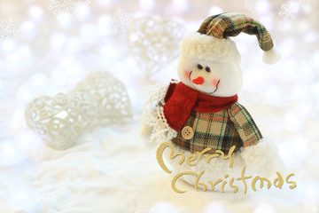 'Merry Christmas' calligraphy card with copy space. Little snowman in the white glitter bokeh...