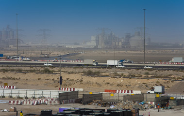 Fototapeta na wymiar road and constructions in United Arab Emirates, Dubai industrial part of city