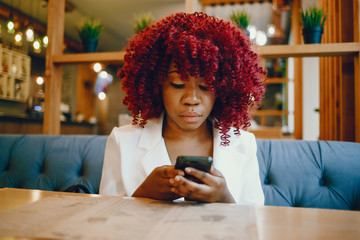 Black girl sitting in a cafe