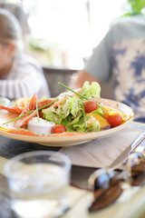 Closeup of fresh salad set on restaurant table