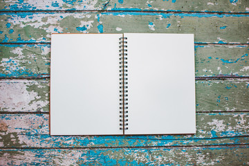 blank notebook on wooden background. soft focus.