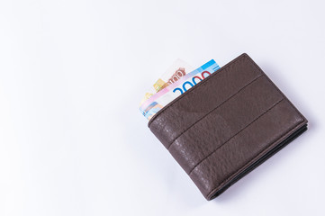 Leather wallet with money on white background