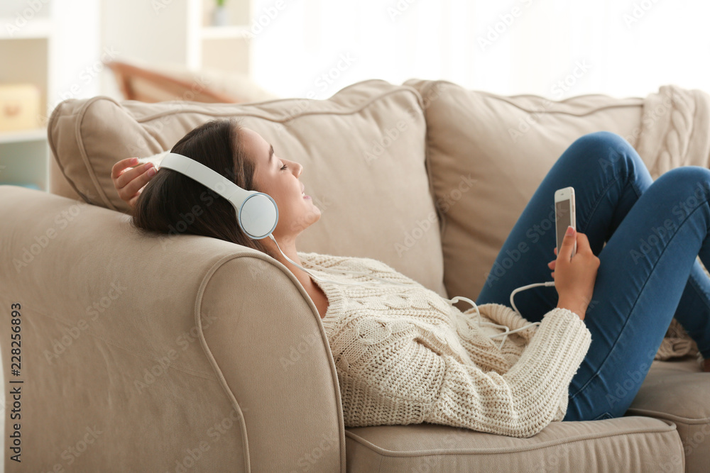 Sticker Beautiful young woman listening to music at home