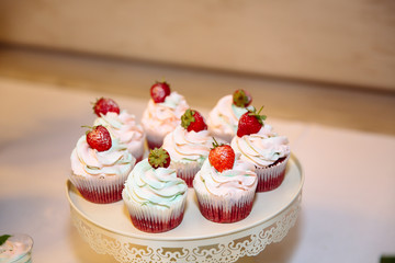 Close-up candy bar, a table with sweets and desserts on the table. Buffet with delicious cupcakes, cake pops, biscuits.