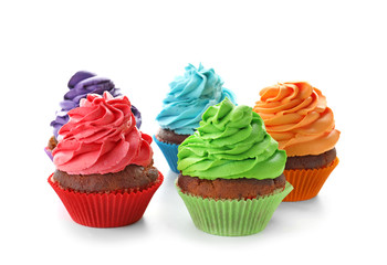 Delicious colorful cupcakes on white background