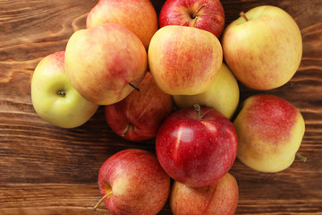 Ripe juicy apples on wooden table