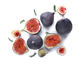 Whole and cut ripe figs on white background