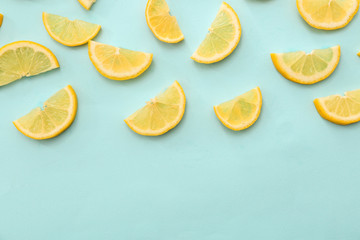 Flat lay composition with lemon slices on color background