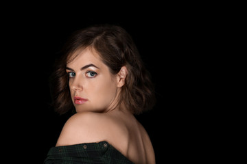 Naklejka premium Portrait of beautiful young woman on dark background