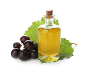 Bottle with grape seed oil on white background