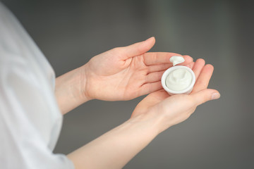 Woman applying body cream, closeup