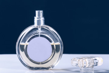 Bottle of perfume on table against black background
