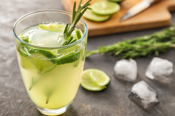 Glass with delicious summer cocktail on table