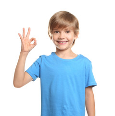 Little boy in t-shirt showing OK gesture on white background