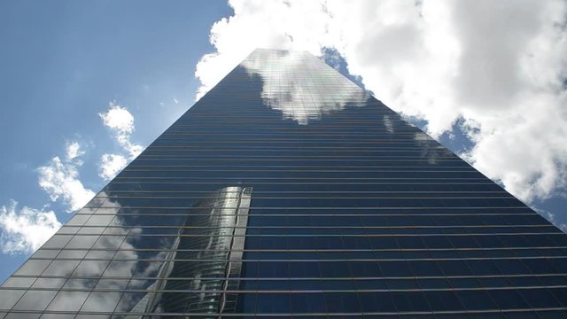 Clouds Reflected on Modern Office Corporation Glass Building