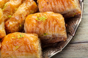 Delicious baklava dessert in oriental bronze setting close up