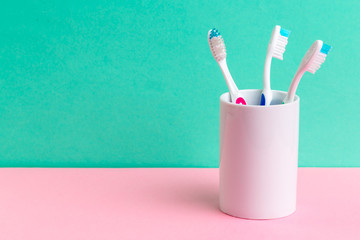 Toothbrushes in glass on the table