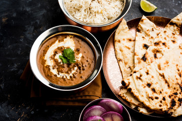 Dal makhani / makhni is a popular dish from India. Made with ingredients like whole black lentil, butter and cream. Served with Naan/roti and rice