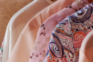 collection of women's clothes hanging on rack for sale