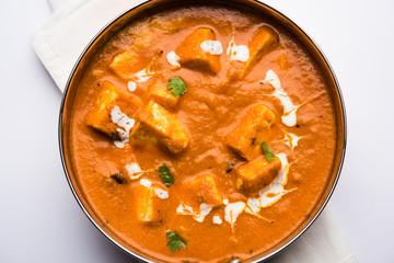 Paneer Butter Masala or Cheese Cottage Curry in serving a bowl or pan, served with or without roti and rice