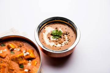 Dal makhani / makhni is a popular dish from India. Made with ingredients like whole black lentil, butter and cream. Served with Naan/roti and rice