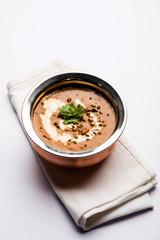 Dal makhani / makhni is a popular dish from India. Made with ingredients like whole black lentil, butter and cream. Served with Naan/roti and rice