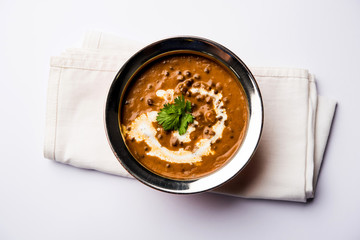Dal makhani / makhni is a popular dish from India. Made with ingredients like whole black lentil, butter and cream. Served with Naan/roti and rice