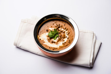 Dal makhani / makhni is a popular dish from India. Made with ingredients like whole black lentil, butter and cream. Served with Naan/roti and rice
