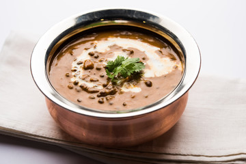 Dal makhani / makhni is a popular dish from India. Made with ingredients like whole black lentil, butter and cream. Served with Naan/roti and rice