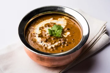 Foto auf Alu-Dibond Dal makhani / makhni is a popular dish from India. Made with ingredients like whole black lentil, butter and cream. Served with Naan/roti and rice © Arundhati