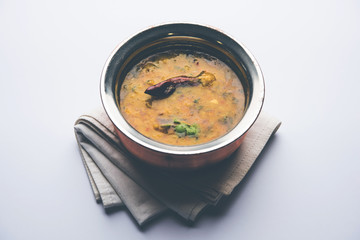 Dal Tadka Fry / Indian Lentil Curry served in a bowl with rice and roti, selective focus