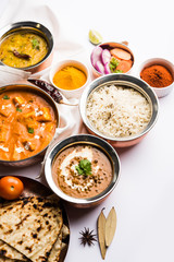 Indian Lunch / Dinner main course food in group includes Paneer Butter Masala, Dal Makhani, Palak Paneer, Roti, Rice etc, Selective focus