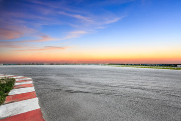 Car racing track and beautiful sky clouds at sunset