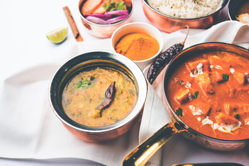 Indian Lunch / Dinner main course food in group includes Paneer Butter Masala, Dal Makhani, Palak Paneer, Roti, Rice etc, Selective focus