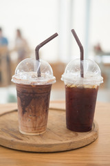 Two iced coffee on wooden tray
