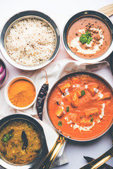 Indian Lunch / Dinner main course food in group includes Paneer Butter Masala, Dal Makhani, Palak Paneer, Roti, Rice etc, Selective focus