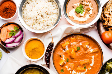 Indian Lunch / Dinner main course food in group includes Paneer Butter Masala, Dal Makhani, Palak Paneer, Roti, Rice etc, Selective focus